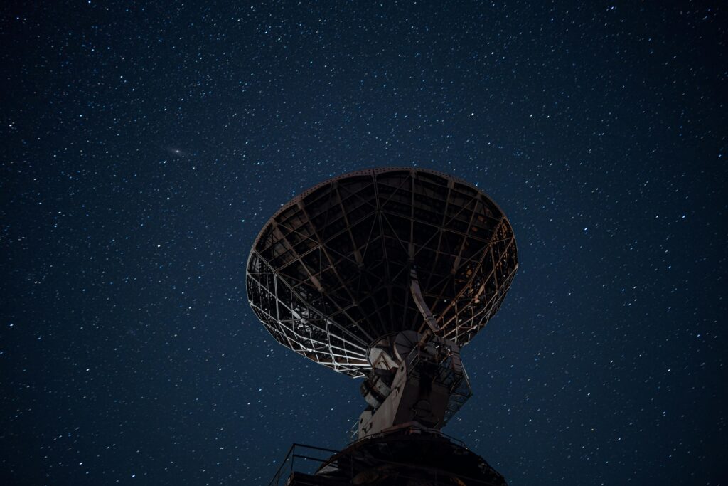 Radio telescope under bright starry sky